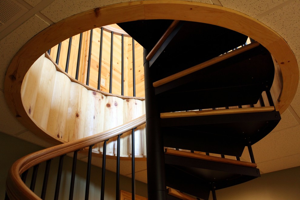 Inspiration for a small traditional wood spiral staircase in Philadelphia with metal risers.