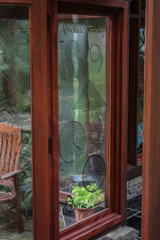 Inspiration for a mid-sized asian shade backyard stone landscaping in Cleveland with a fire pit.