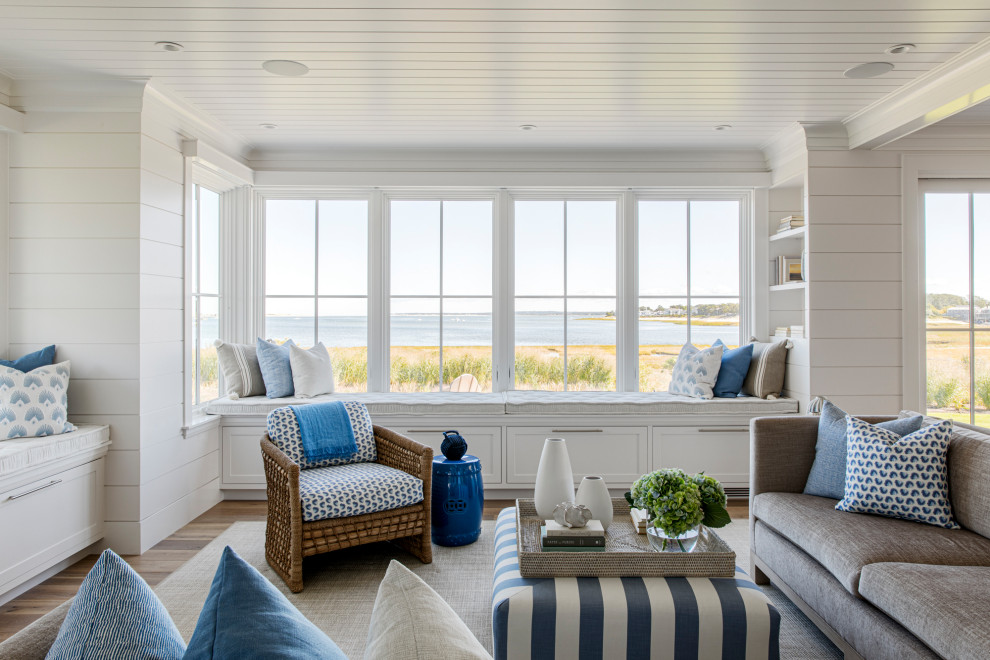 Design ideas for a large beach style open concept family room in Boston with white walls, medium hardwood floors, a wall-mounted tv, timber and planked wall panelling.