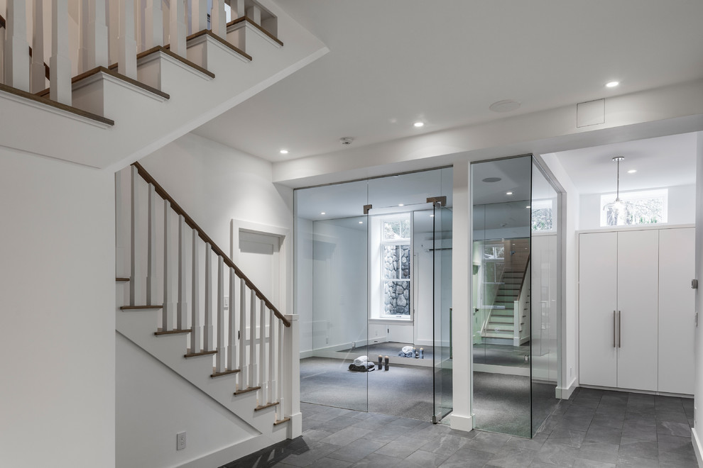 This is an example of a large transitional multipurpose gym in Boston with white walls and grey floor.