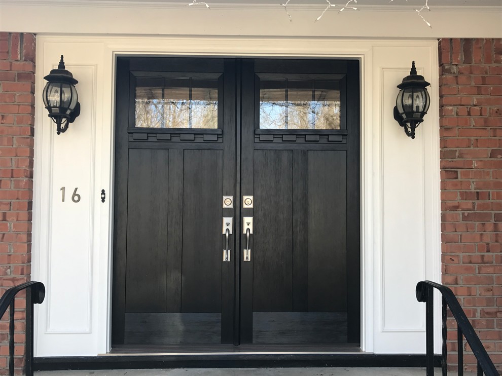 Arts and crafts entryway in New York with a double front door and a black front door.