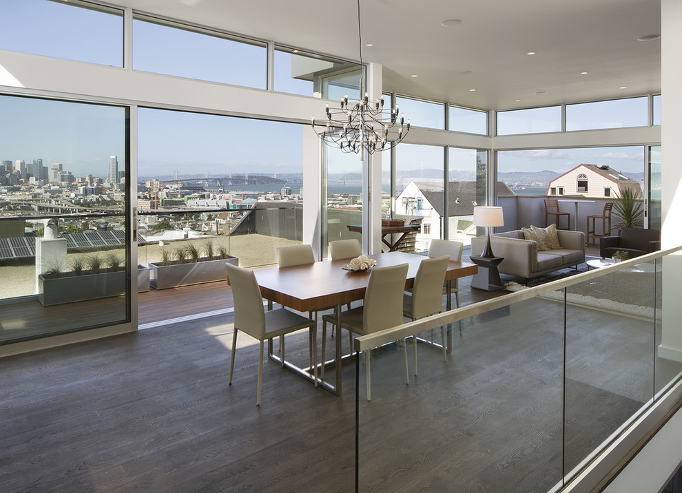 Contemporary open plan dining in San Francisco with white walls and dark hardwood floors.
