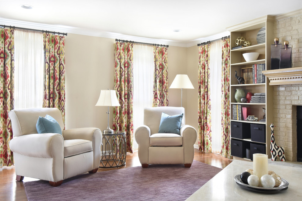 Large eclectic enclosed family room in Atlanta with beige walls, medium hardwood floors, a standard fireplace, a brick fireplace surround and beige floor.