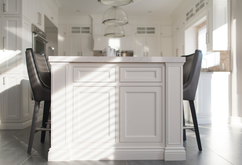 Eat-in kitchen - transitional porcelain tile and gray floor eat-in kitchen idea in Toronto with an undermount sink, beaded inset cabinets, white cabinets, quartzite countertops, brick backsplash, stainless steel appliances, an island and white countertops