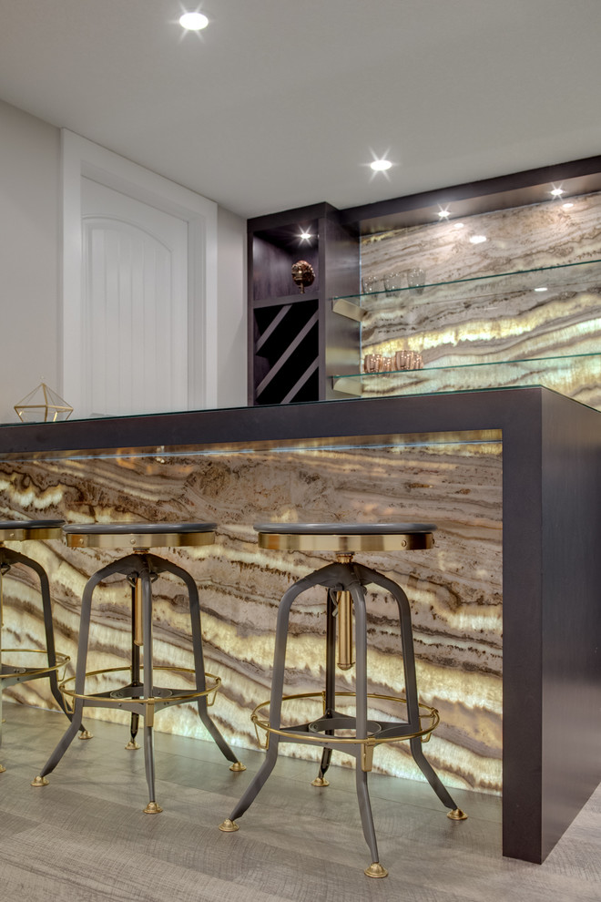 Photo of a mid-sized contemporary galley seated home bar in Calgary with no sink, flat-panel cabinets, brown cabinets, quartz benchtops, multi-coloured splashback, stone slab splashback, vinyl floors, grey floor and brown benchtop.