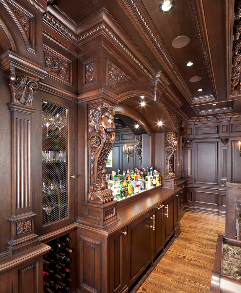 Design ideas for a large traditional u-shaped seated home bar in DC Metro with an undermount sink, raised-panel cabinets, brown cabinets, granite benchtops, medium hardwood floors and brown floor.