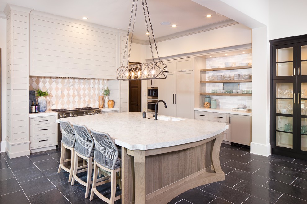 Inspiration for a beach style galley kitchen in Orlando with an undermount sink, shaker cabinets, beige cabinets, beige splashback, with island, black floor and white benchtop.