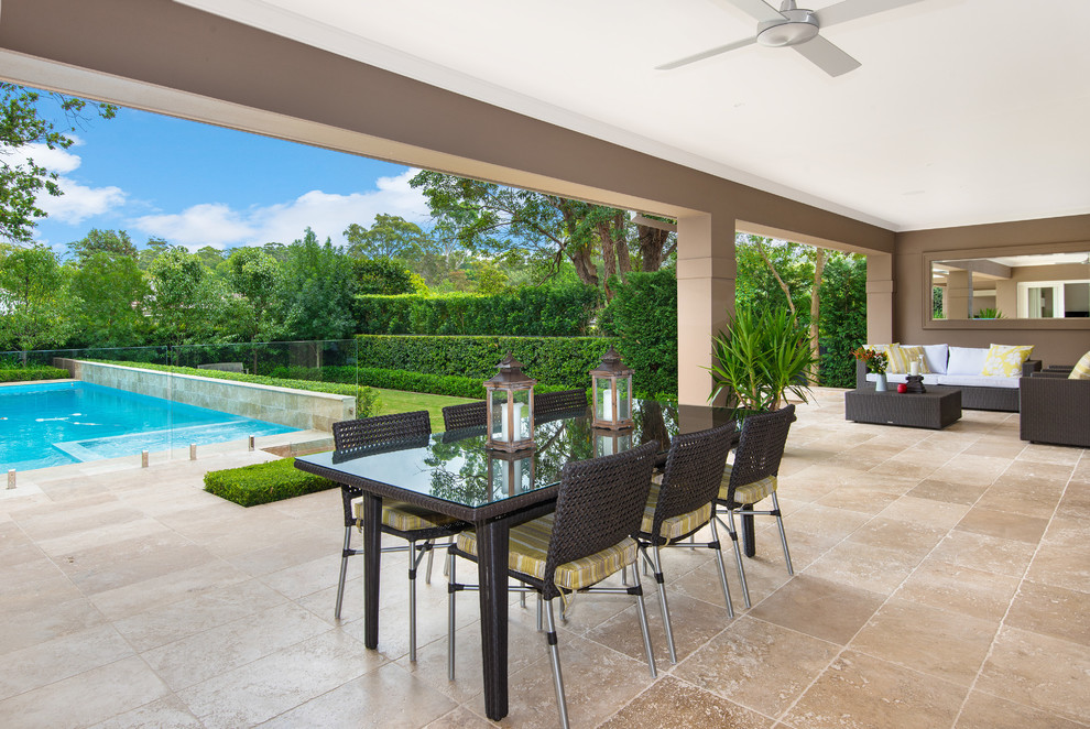 This is an example of a large contemporary backyard patio in Sydney with tile and a roof extension.