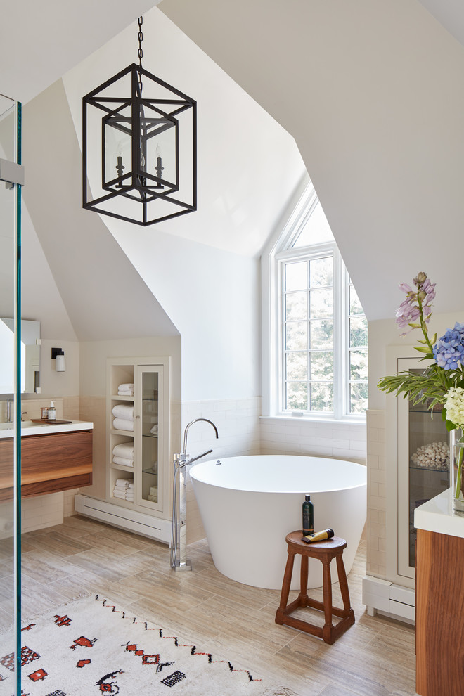 This is an example of a large contemporary master bathroom in Boston with flat-panel cabinets, medium wood cabinets, a japanese tub, an open shower, a two-piece toilet, beige tile, ceramic tile, white walls, ceramic floors, an integrated sink, solid surface benchtops, a hinged shower door, white benchtops and brown floor.