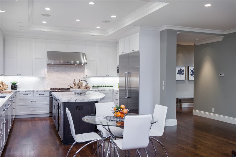 Enclosed kitchen - mid-sized transitional l-shaped dark wood floor and brown floor enclosed kitchen idea in San Francisco with an undermount sink, shaker cabinets, gray cabinets, marble countertops, gray backsplash, marble backsplash, stainless steel appliances and an island
