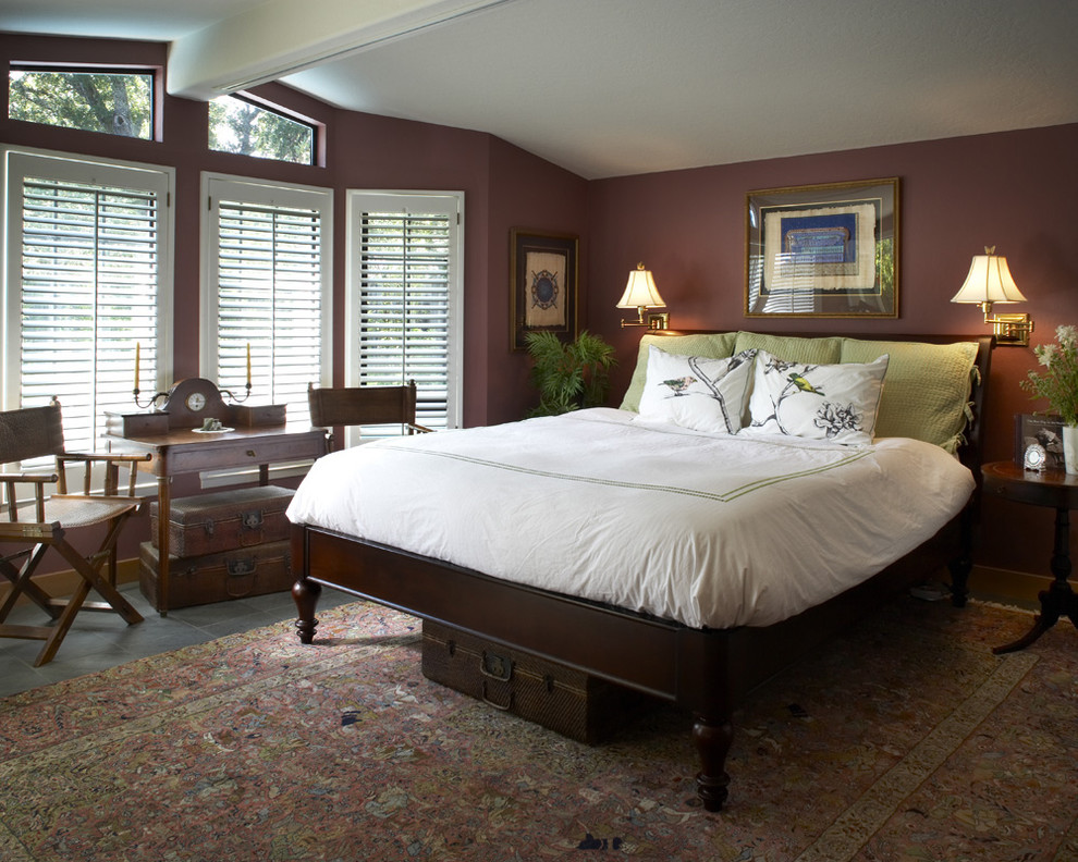 This is an example of a traditional master bedroom in San Francisco with no fireplace, slate floors and brown walls.