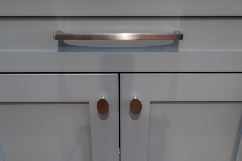 Inspiration for a mid-sized transitional u-shaped laminate floor, brown floor and coffered ceiling eat-in kitchen remodel in Denver with an undermount sink, shaker cabinets, blue cabinets, quartz countertops, white backsplash, ceramic backsplash, stainless steel appliances, an island and white countertops