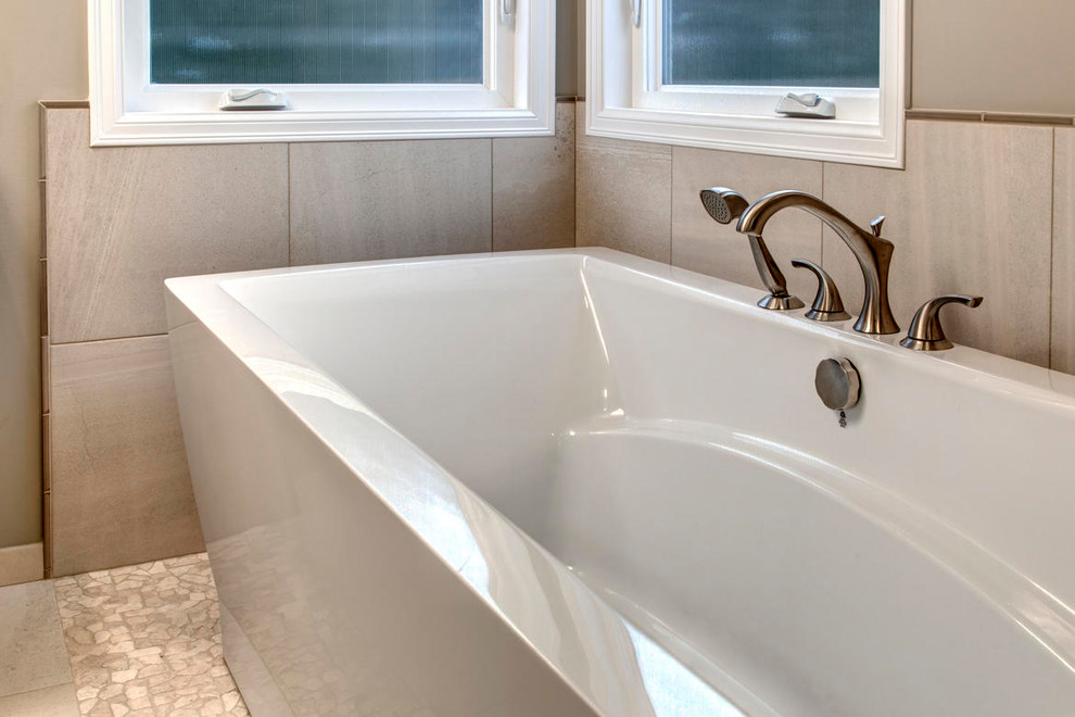 Example of a large transitional master multicolored tile and matchstick tile pebble tile floor freestanding bathtub design in Seattle with shaker cabinets, dark wood cabinets, a two-piece toilet, beige walls, an undermount sink and quartz countertops