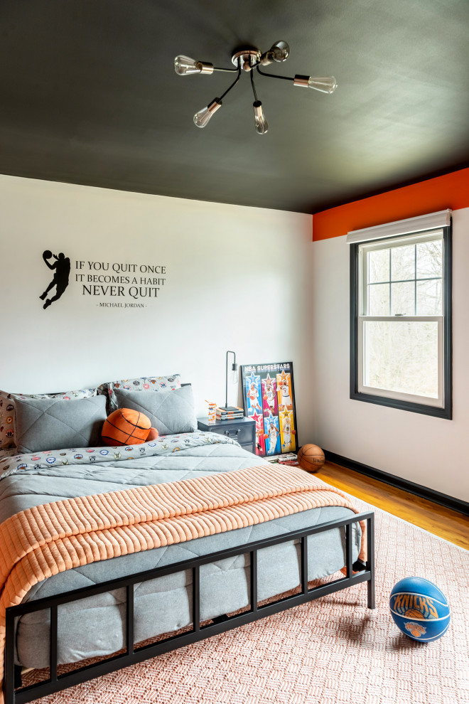 Inspiration for a mid-sized contemporary bedroom in New York with orange walls.