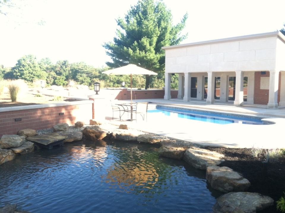 Example of a mid-sized backyard pool fountain design