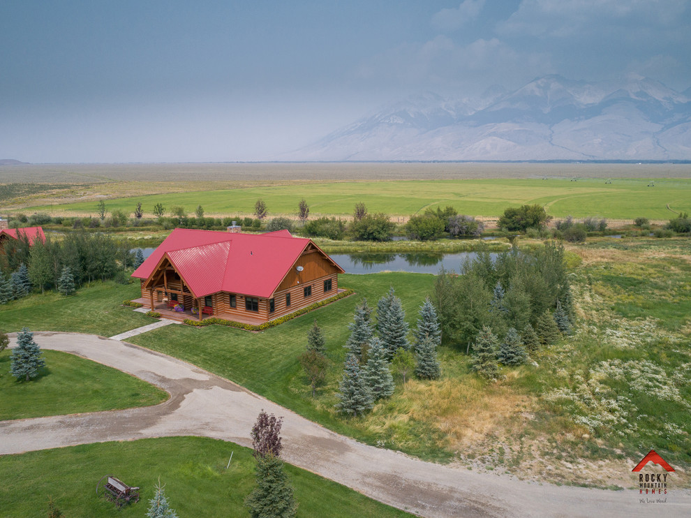 Mid-sized rustic brown one-story wood gable roof idea with a metal roof