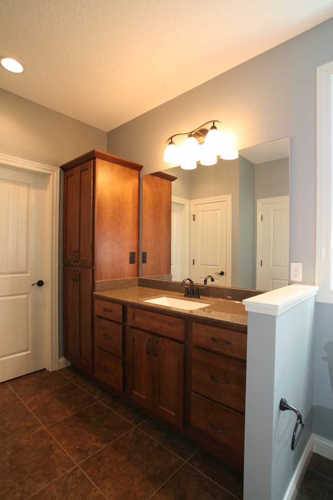 Bathroom - transitional brown tile and ceramic tile bathroom idea in Chicago with an integrated sink, flat-panel cabinets and medium tone wood cabinets