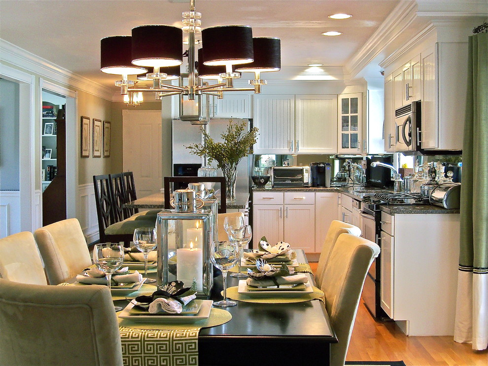 This is an example of a traditional eat-in kitchen in Boston with white cabinets and stainless steel appliances.