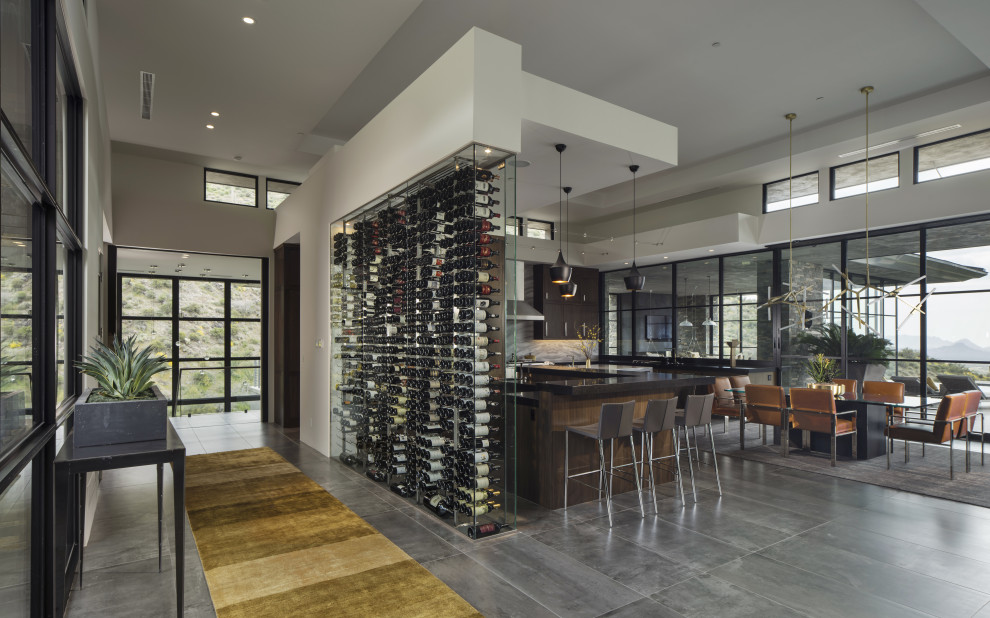 Photo of a small contemporary wine cellar in Phoenix with storage racks, concrete floors and grey floor.