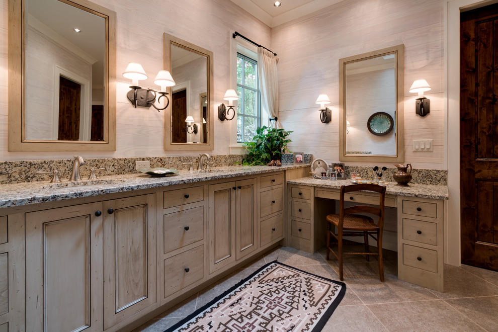 Inspiration for a large country master bathroom in Other with recessed-panel cabinets, distressed cabinets, an alcove shower, a one-piece toilet, brown tile, stone tile, black walls, porcelain floors, an undermount sink and granite benchtops.