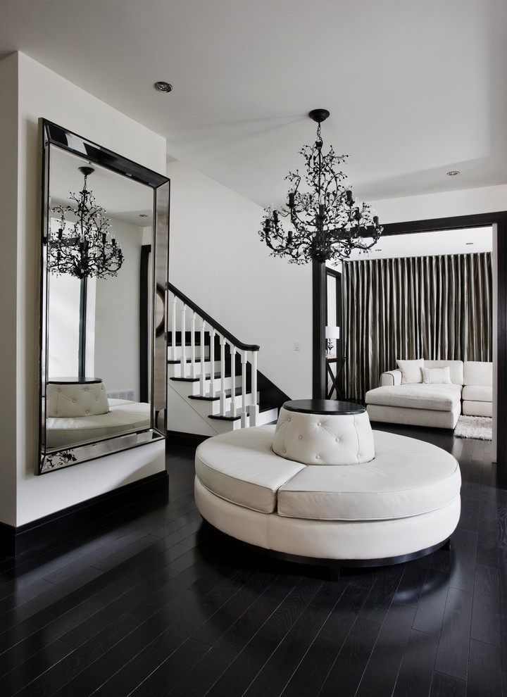 Design ideas for a large contemporary foyer in Montreal with white walls, black floor and painted wood floors.