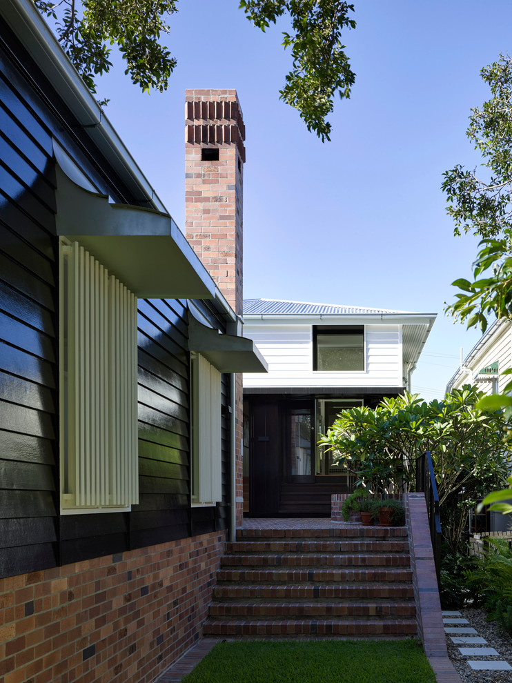 Transitional one-storey white exterior in Brisbane with wood siding and a hip roof.