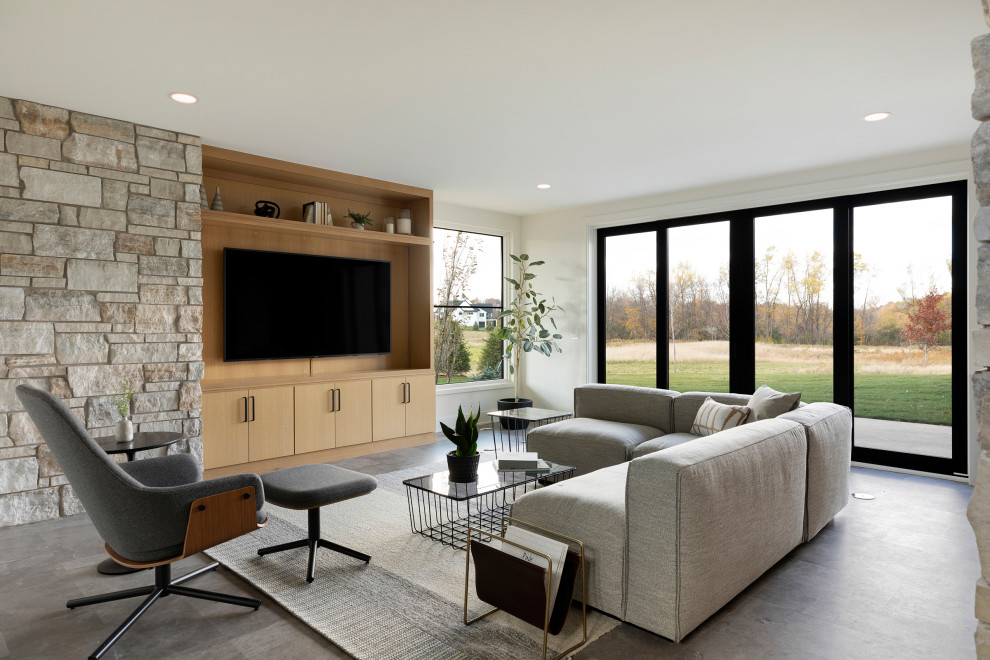 Photo of a country family room in Minneapolis with white walls and grey floor.