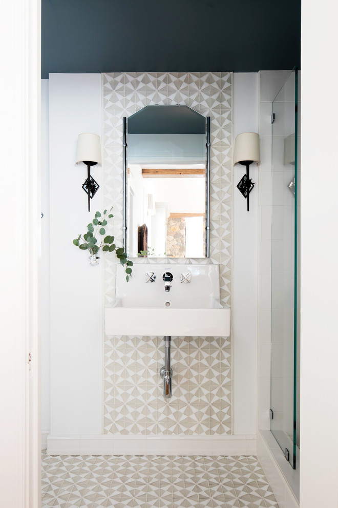 Photo of a small beach style 3/4 bathroom with an alcove shower, white tile, glass tile, white walls, mosaic tile floors, a wall-mount sink, white floor and a hinged shower door.