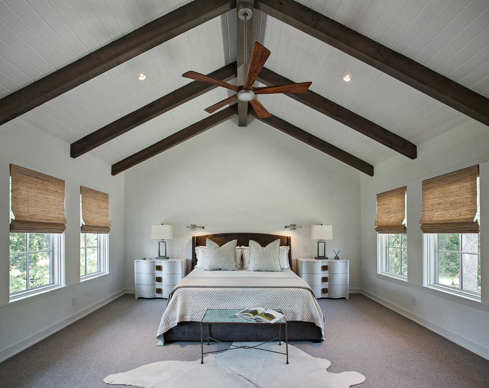 Country master bedroom in Houston with white walls, carpet and brown floor.
