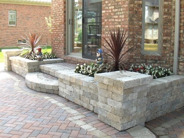 Design ideas for a transitional backyard patio in Detroit with brick pavers.