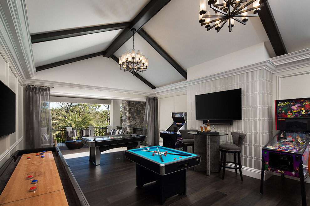 This is an example of a traditional family room in Miami with multi-coloured walls, dark hardwood floors, brown floor, a game room, no fireplace and a wall-mounted tv.