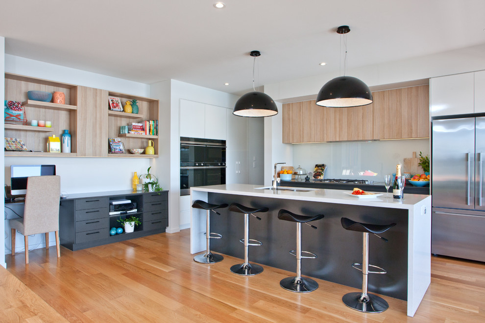 Design ideas for a contemporary kitchen in Sunshine Coast with black cabinets, quartz benchtops, glass sheet splashback and with island.