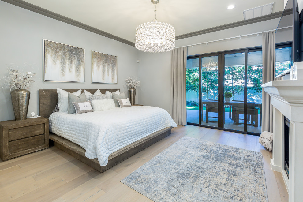 Photo of a transitional bedroom in Orlando with grey walls, light hardwood floors and white floor.