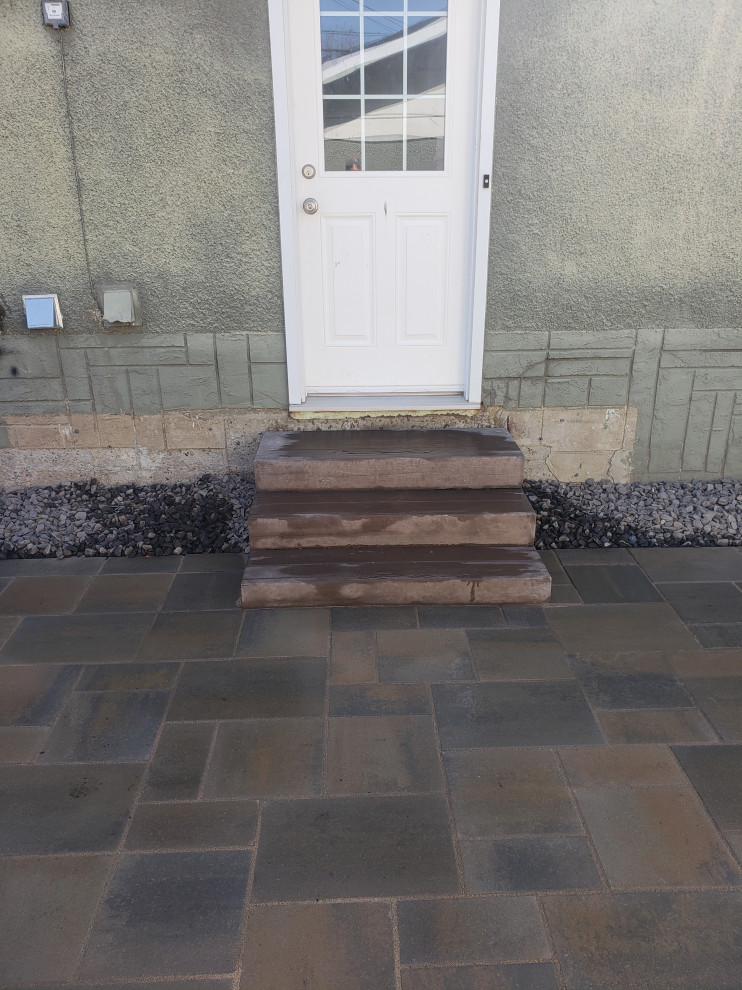 Photo of a small rustic shade backyard concrete paver landscaping in Edmonton for summer.