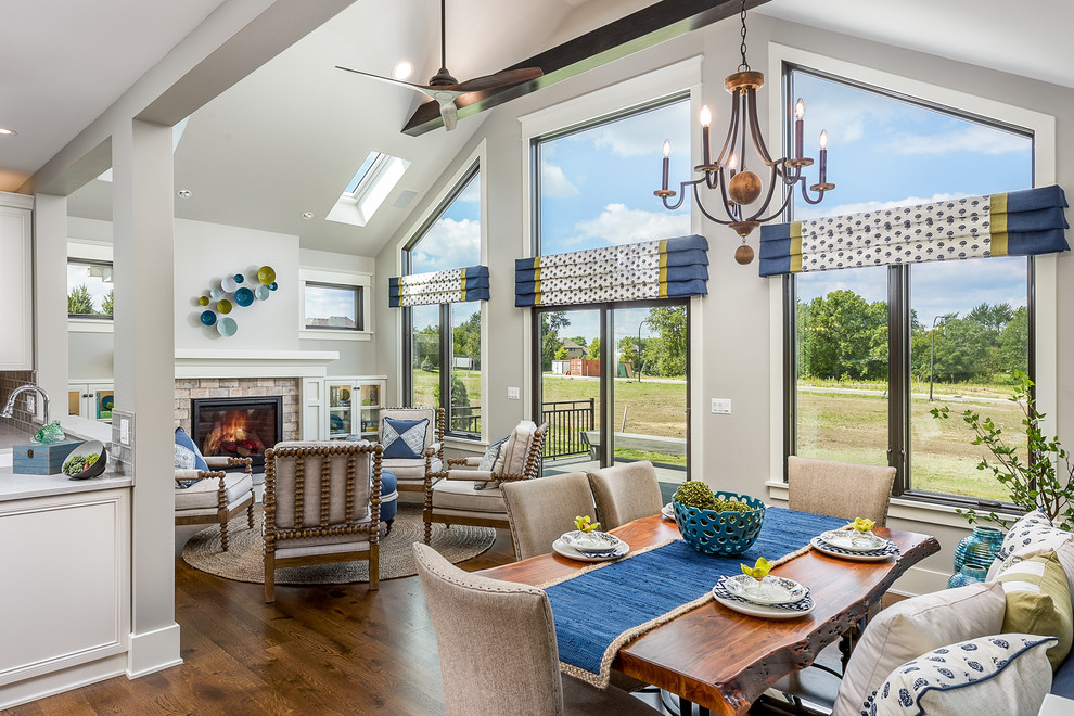 Large trendy dark wood floor and brown floor sunroom photo in Chicago with a standard fireplace, a stone fireplace and a skylight