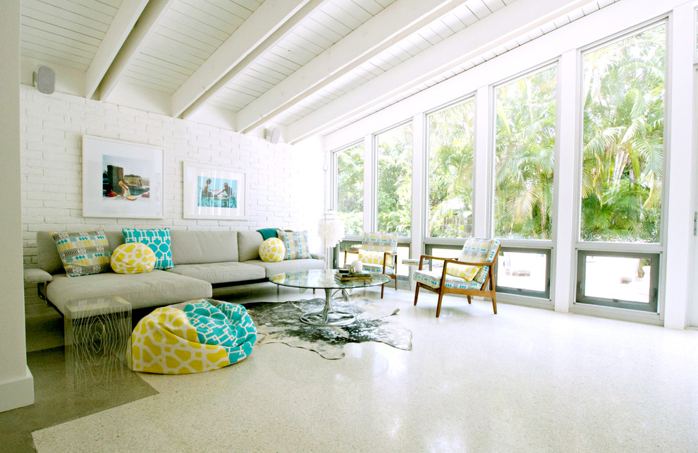 Inspiration for a beach style living room in Miami with white walls.