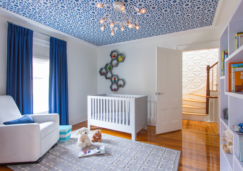Mid-sized contemporary nursery in Boston with white walls, medium hardwood floors and orange floor for boys.