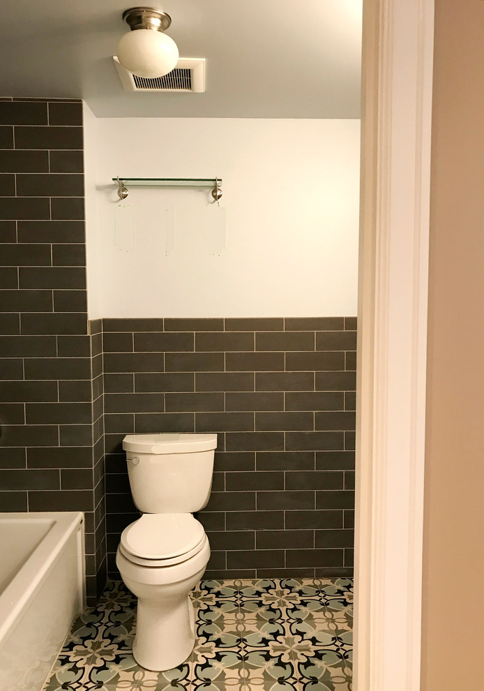 Photo of a small traditional 3/4 bathroom in Seattle with an alcove tub, a shower/bathtub combo, a one-piece toilet, gray tile, porcelain tile, blue walls, cement tiles, a pedestal sink, blue floor, a shower curtain, shaker cabinets and white cabinets.