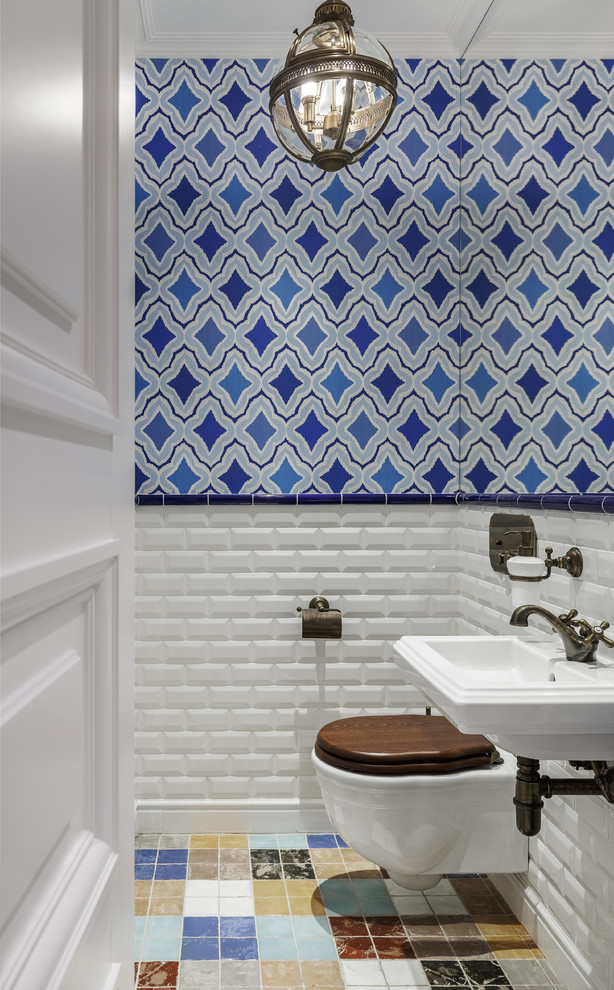 Inspiration for a transitional powder room in Moscow with a wall-mount toilet, white tile, subway tile, a wall-mount sink and multi-coloured floor.
