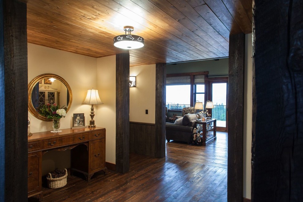 Inspiration for a mid-sized rustic dark wood floor hallway remodel with beige walls