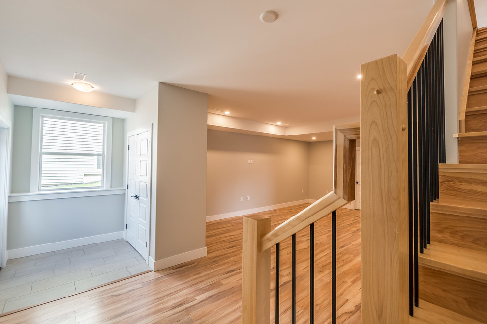 Example of a transitional walk-out light wood floor and beige floor basement design