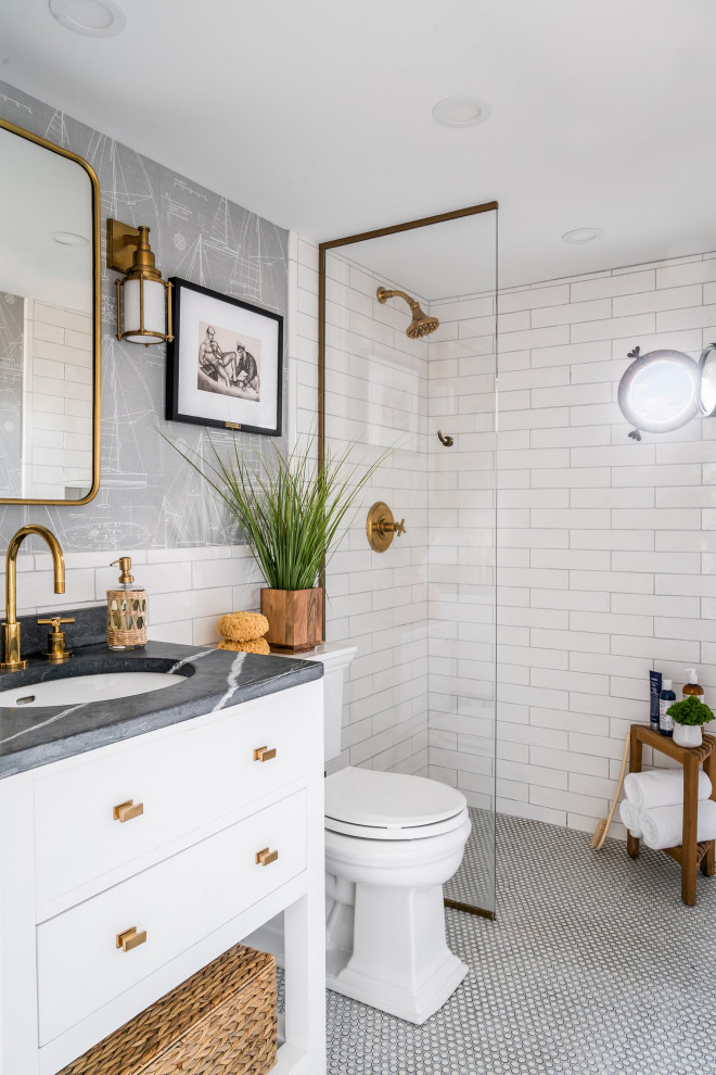 This is an example of a mid-sized beach style master bathroom in Boston with white cabinets, white tile, grey walls, grey benchtops, a single vanity, wallpaper, flat-panel cabinets, a curbless shower, subway tile, mosaic tile floors, an undermount sink, white floor, an open shower and a freestanding vanity.