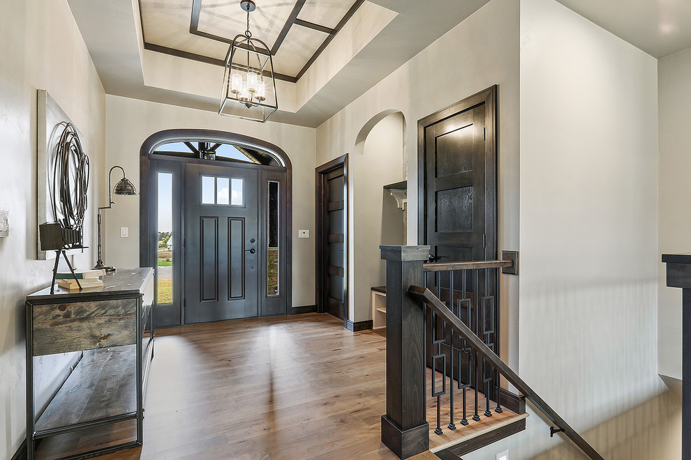 Inspiration for a large arts and crafts foyer in Other with grey walls, light hardwood floors, a single front door, a brown front door and brown floor.