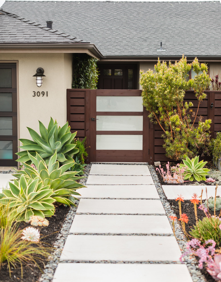 Inspiration for a mid-sized contemporary front yard xeriscape in San Luis Obispo with concrete pavers.