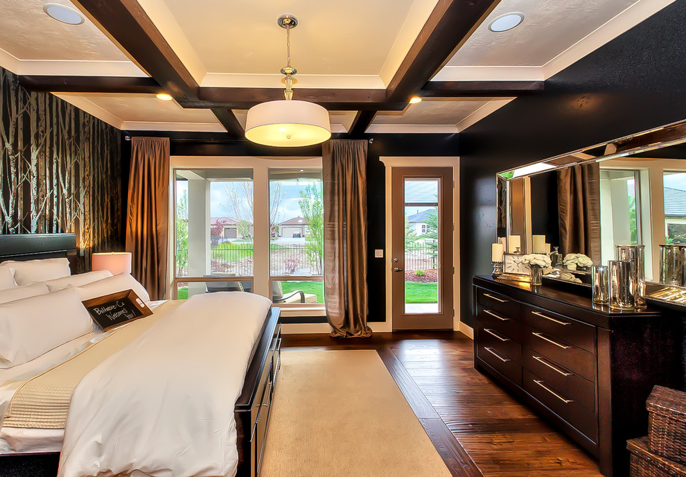 This is an example of a mid-sized country master bedroom in Boise with black walls and carpet.
