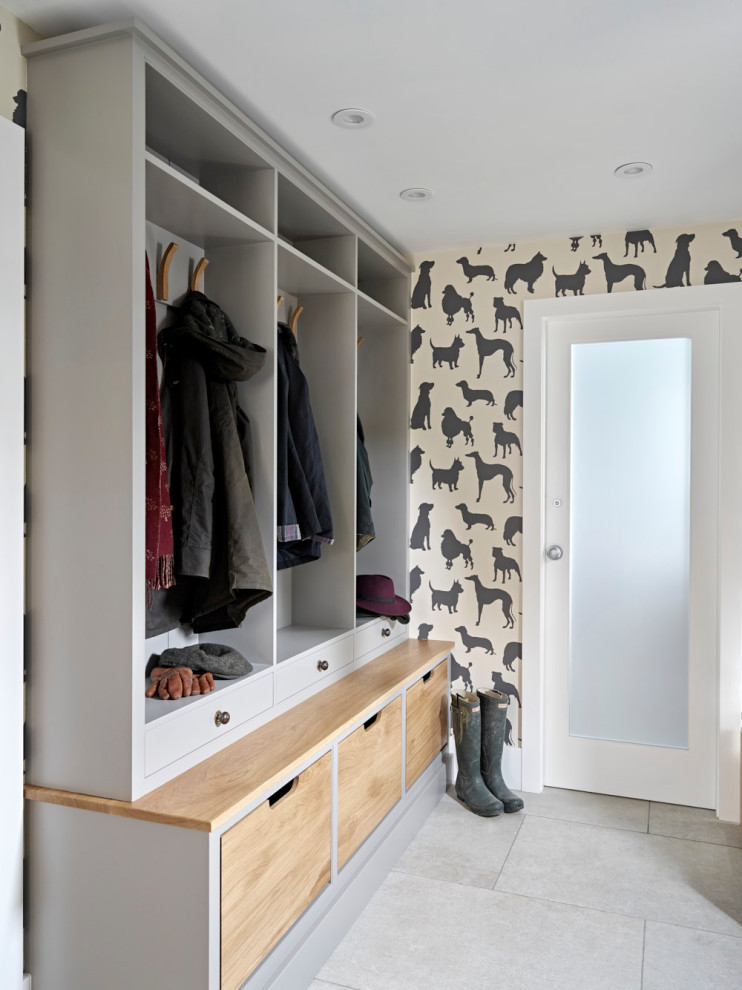 This is an example of a mid-sized country mudroom in Other with multi-coloured walls, grey floor and wallpaper.