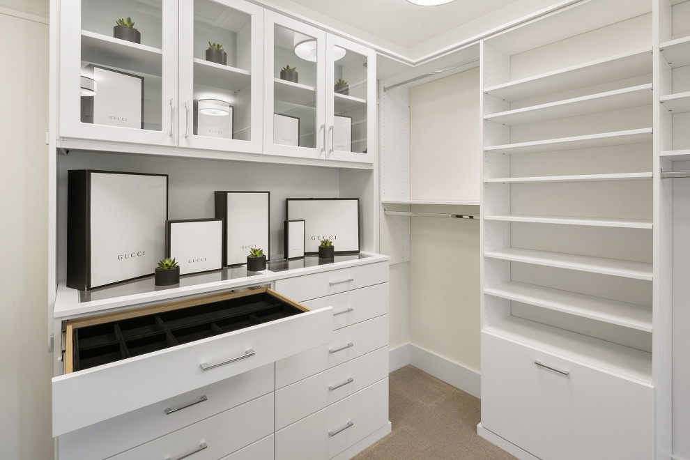 Large country gender-neutral walk-in wardrobe in Seattle with flat-panel cabinets, white cabinets, carpet and grey floor.