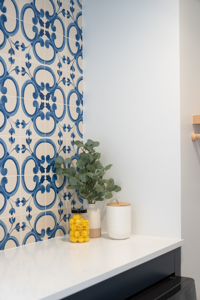 Transitional laundry room photo with ceramic backsplash