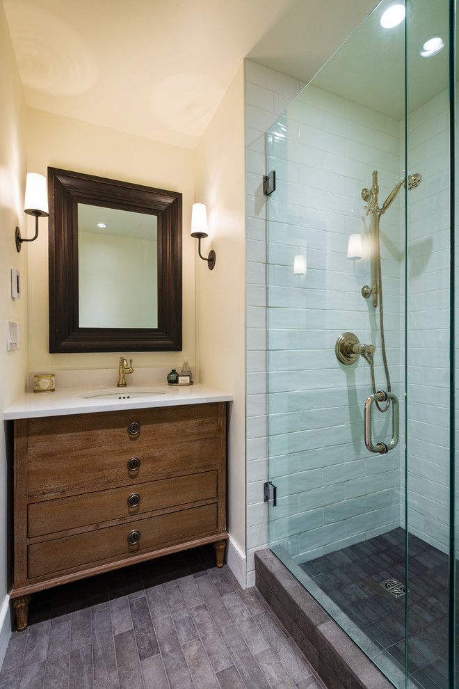 Corner shower - small rustic 3/4 white tile and ceramic tile porcelain tile and gray floor corner shower idea in Vancouver with flat-panel cabinets, medium tone wood cabinets, beige walls, an undermount sink, quartz countertops, a hinged shower door and white countertops