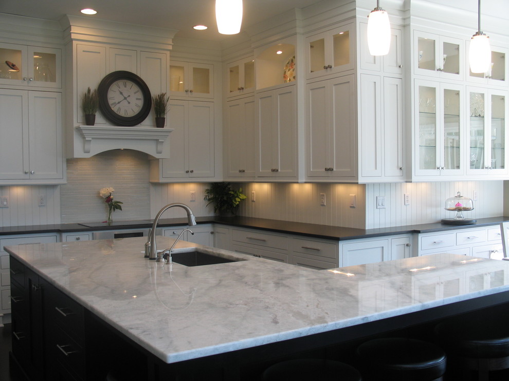 Large transitional l-shaped dark wood floor eat-in kitchen photo in Indianapolis with an undermount sink, recessed-panel cabinets, white cabinets, laminate countertops, white backsplash, ceramic backsplash, stainless steel appliances and an island